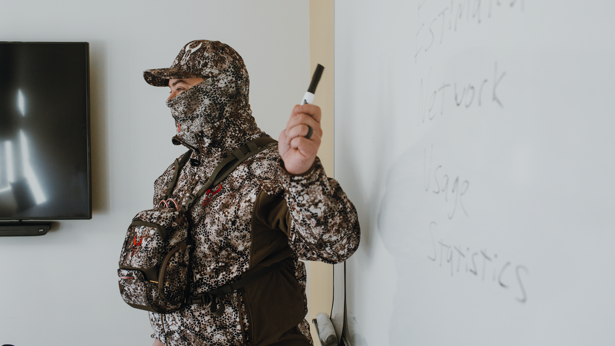 man in Badlands gear in front of whiteboard