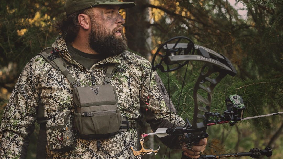 male bow hunter in a forest