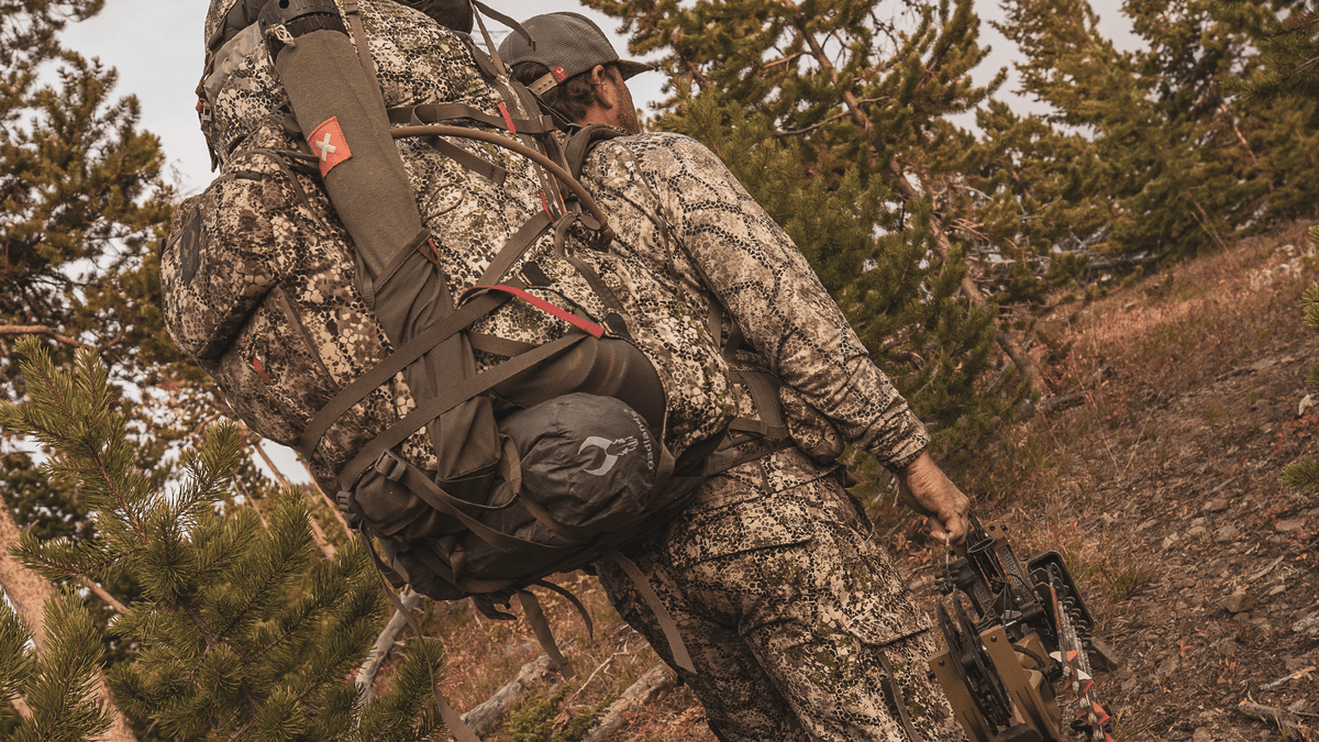 man hauling large hunting pack