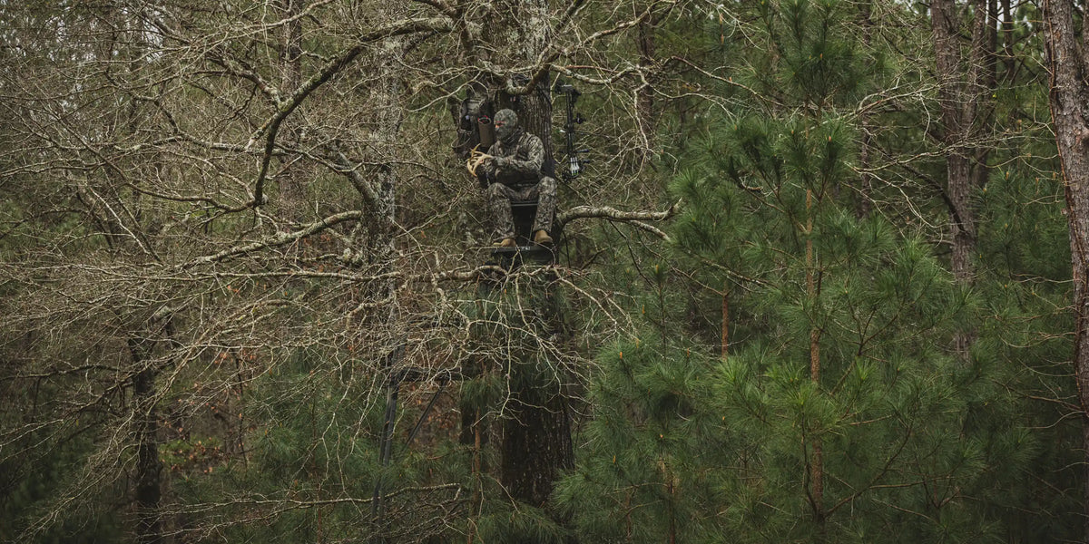 hunter in tree wearing badlands rise pro gear