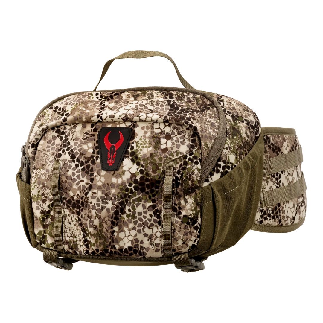 Badlands camo waist pack with red skull logo, top handle, and side pockets, designed for outdoor and hunting use.