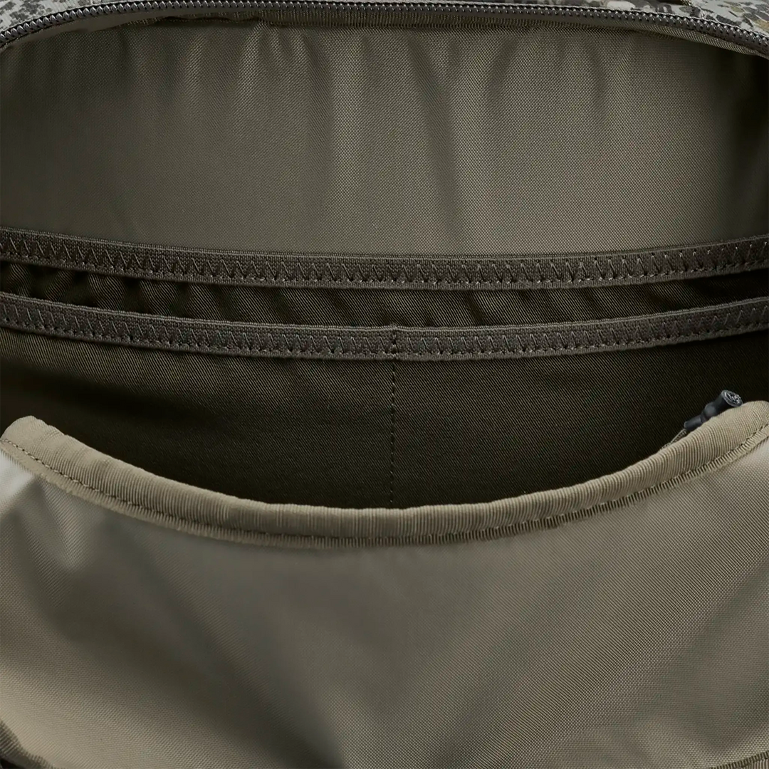 Close-up of interior pockets in a Badlands backpack, showing organized compartments for gear storage.
