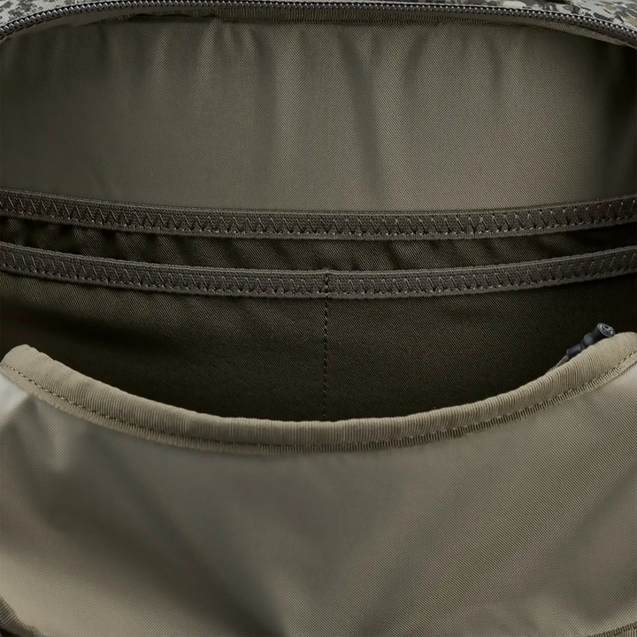 Close-up of interior pockets in a Badlands backpack, showing organized compartments for gear storage.