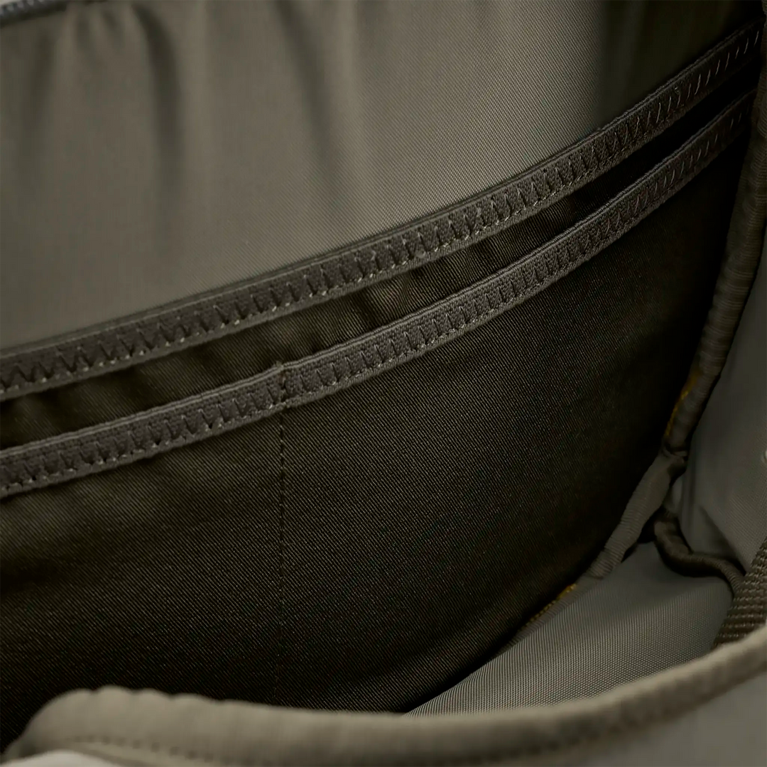 Close-up of interior Badlands backpack pocket, showing reinforced stitching and durable fabric for organized storage.