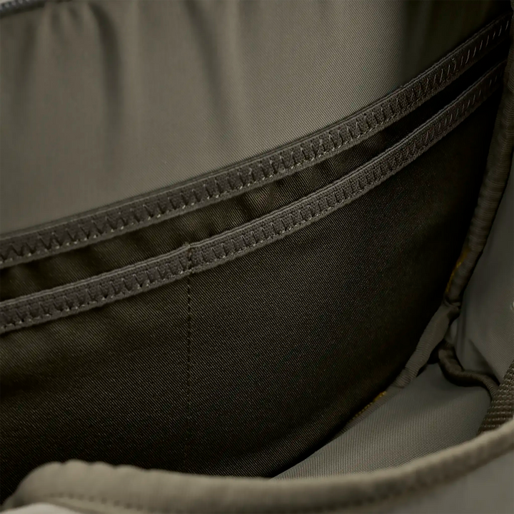 Close-up of interior Badlands backpack pocket, showing reinforced stitching and durable fabric for organized storage.