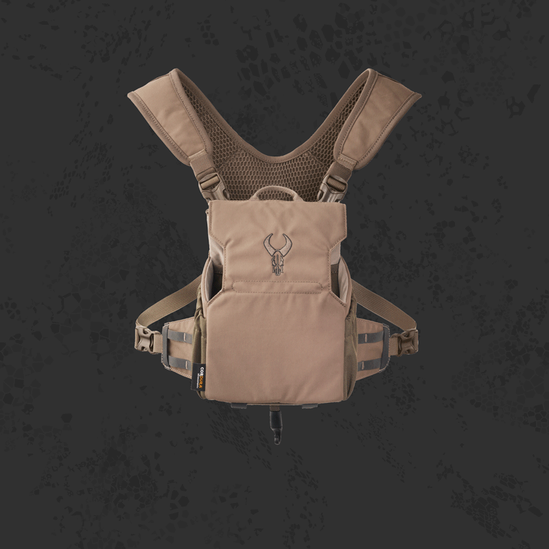 Tan Badlands chest pack with padded straps and Badlands skull logo, displayed on a dark textured background.