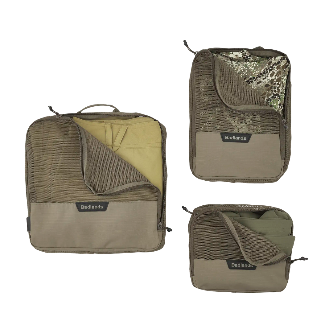 Three Badlands packing cubes in various sizes, each with mesh zippered fronts and the Badlands skull logo visible.