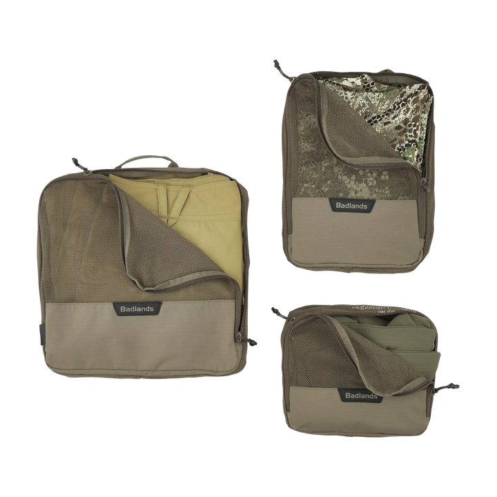 Three Badlands packing cubes in various sizes, each with mesh zippered fronts and the Badlands skull logo visible.