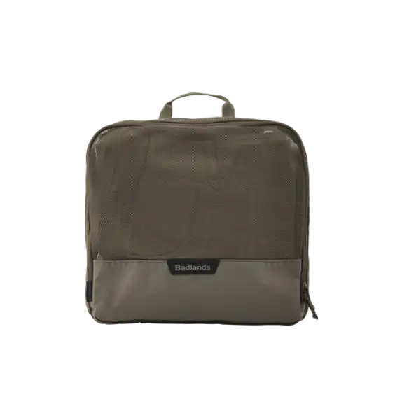 Square tan Badlands packing cube with mesh front, zipper closure, top handle, and Badlands logo on the front.