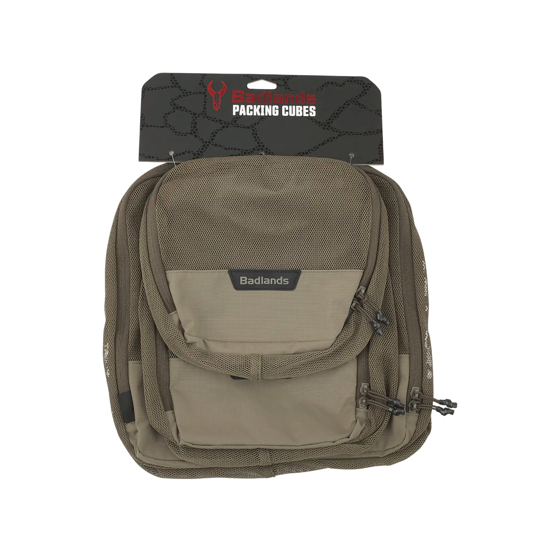 Tan Badlands packing cubes with logo skull, mesh pocket, and zippers, designed for organized gear storage.