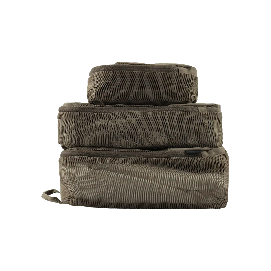 Three stacked Badlands packing cubes in tan mesh, featuring the Badlands skull logo on each cube.