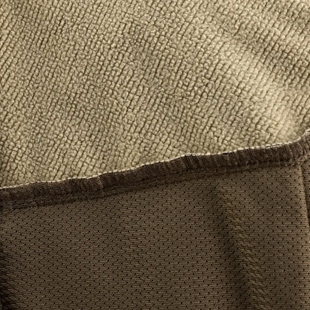 Close-up of Badlands fabric showing tan fleece and brown mesh textures; no visible logo or skull in this image.