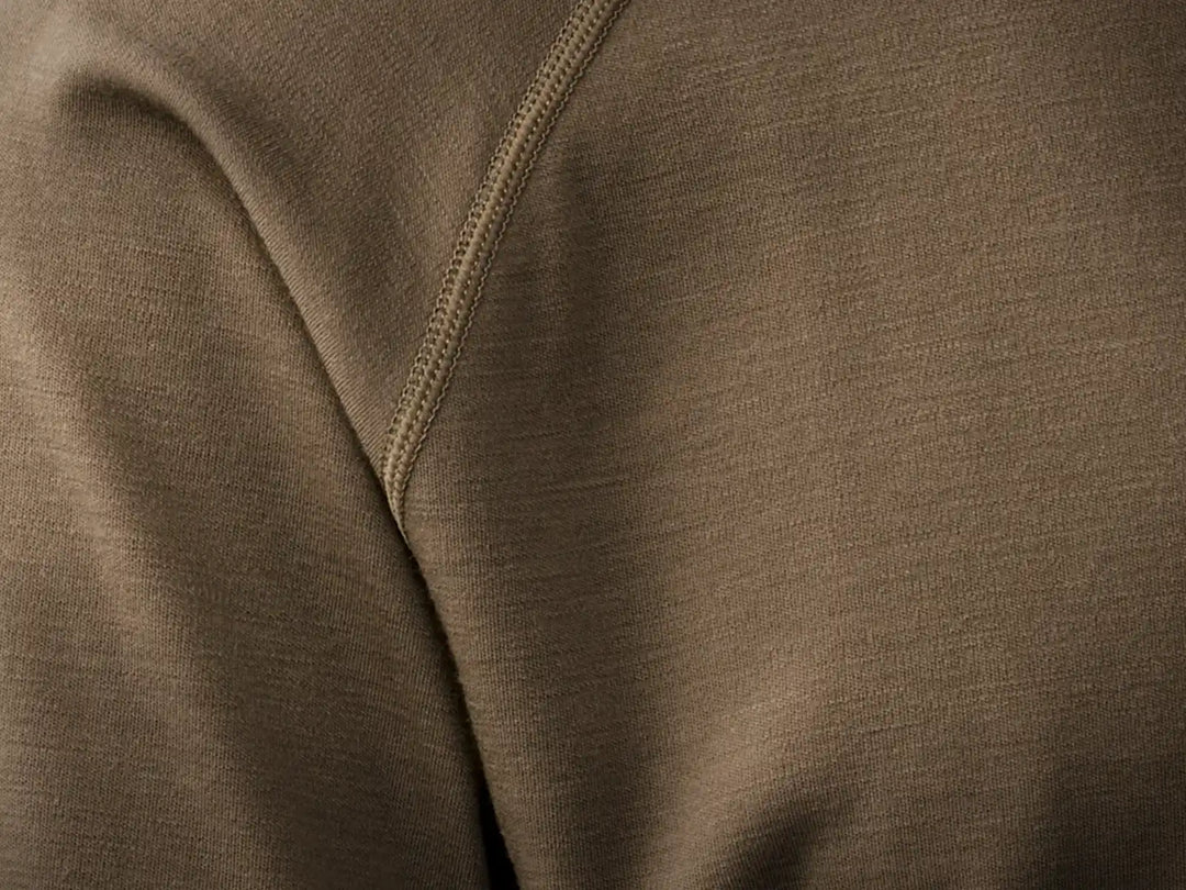 Close-up of brown Badlands fabric with visible stitching; smooth texture, no visible logo or pattern.