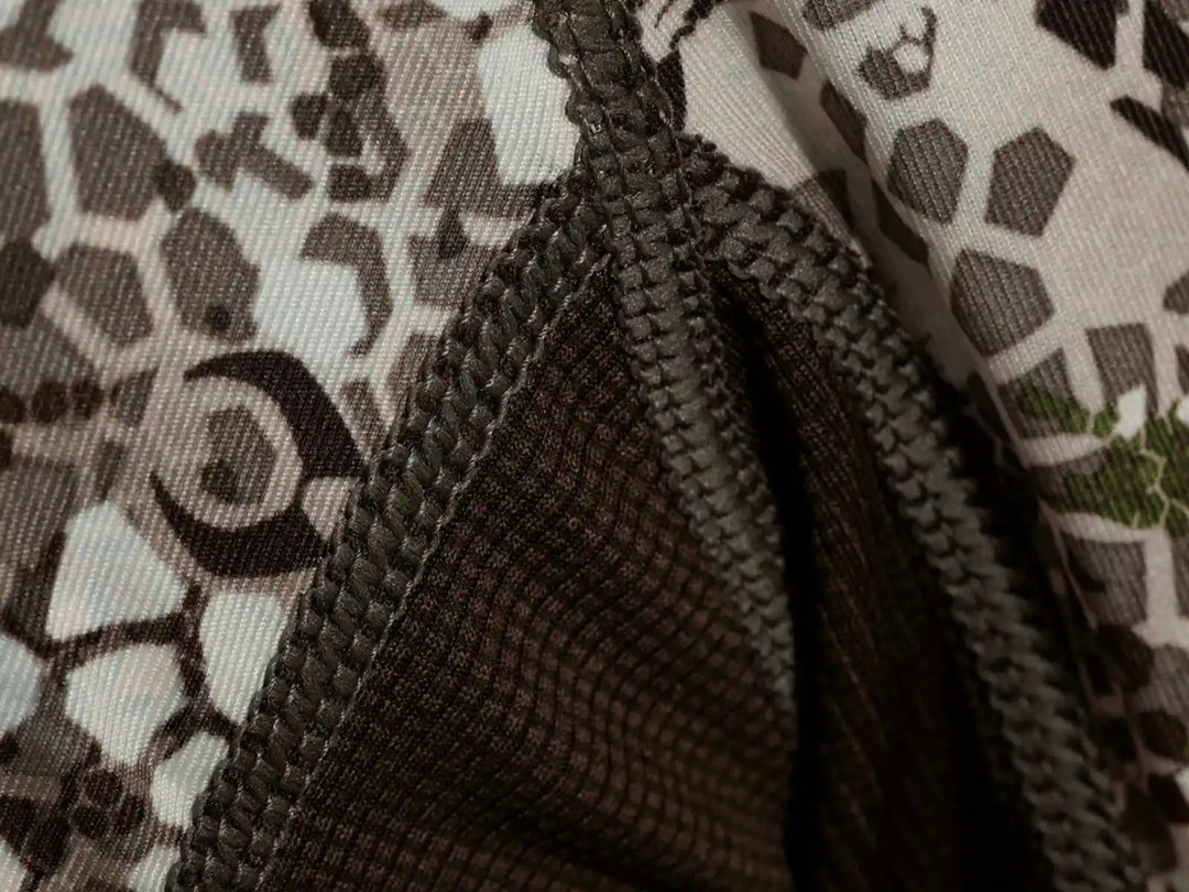 Close-up of Badlands camo fabric with reinforced stitching and visible skull logo for brand identification.