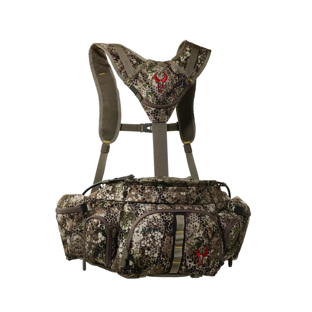 Badlands camo hunting pack with harness and red skull logo, multiple zippered pockets, ADA-optimized for outdoor use.
