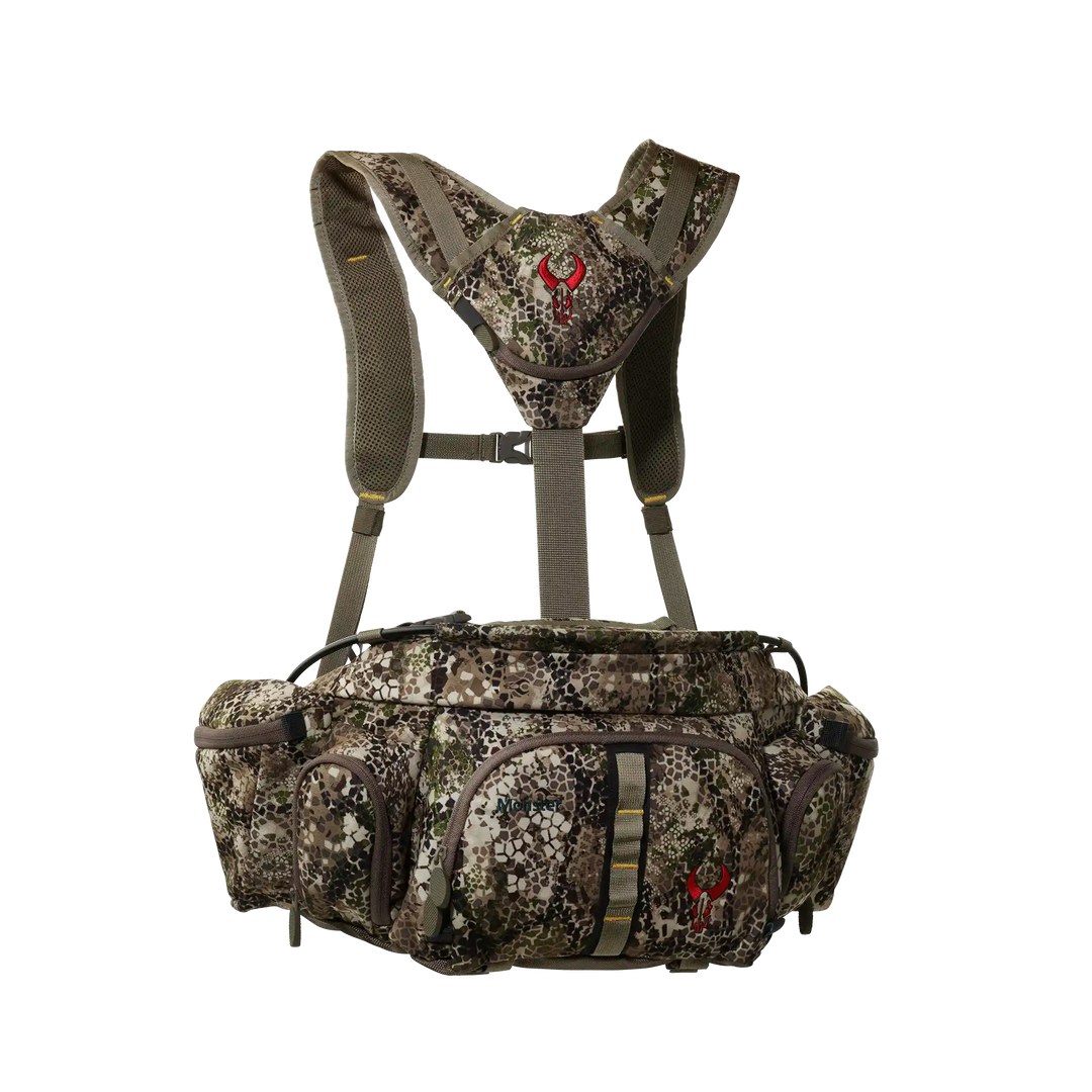 Badlands camo hunting pack with harness and red skull logo, multiple zippered pockets, ADA-optimized for outdoor use.