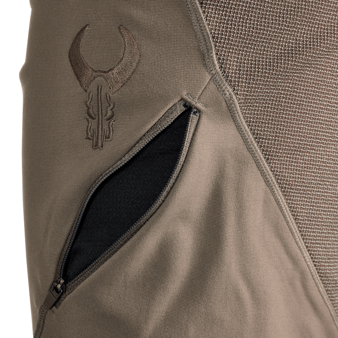 Close-up of a Badlands jacket pocket with the embroidered Badlands skull logo above the zippered opening.