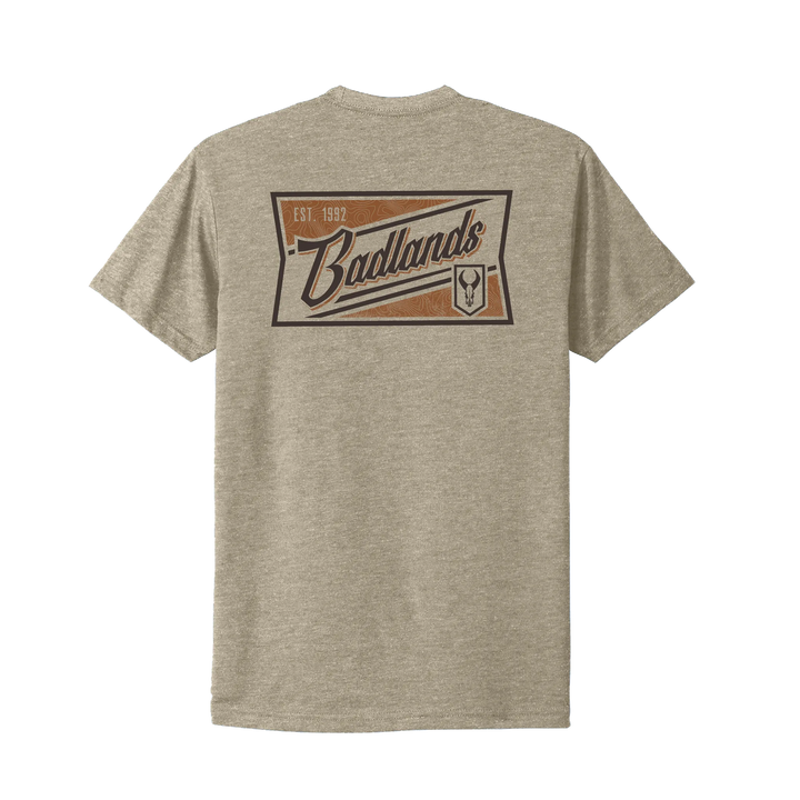 Tan Badlands t-shirt with large logo, "Est. 1992," and skull emblem on back. High-contrast, easy-to-read design.