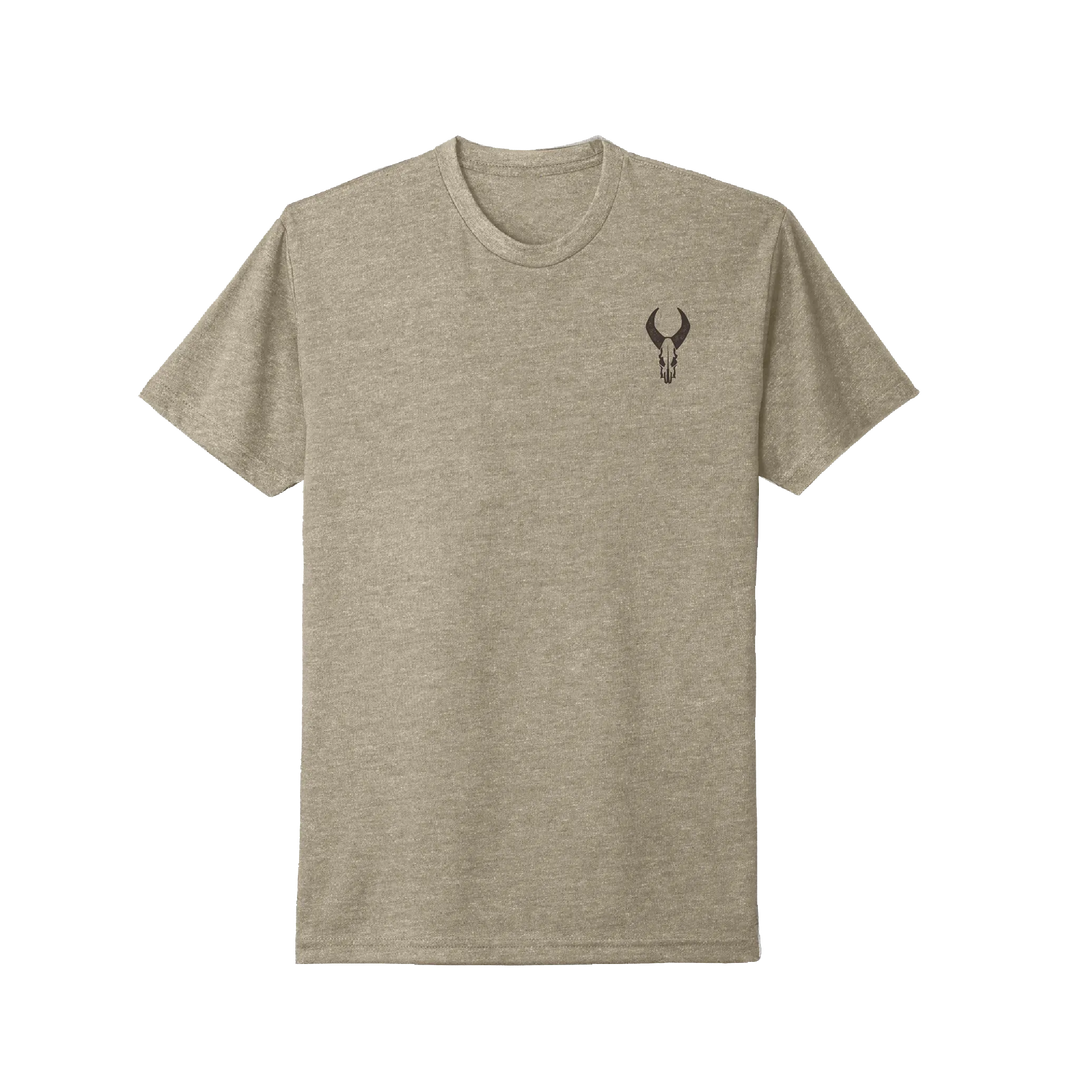 Heather tan Badlands t-shirt with black skull logo on left chest. Simple, ADA-friendly design.