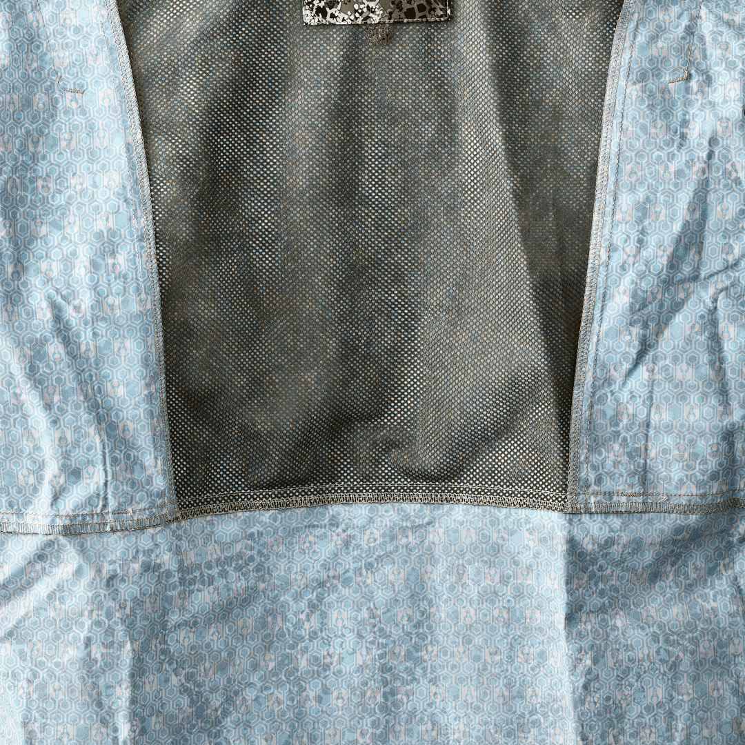 Close-up of a Badlands jacket interior showing mesh lining and the signature Badlands skull logo on the neck tag.