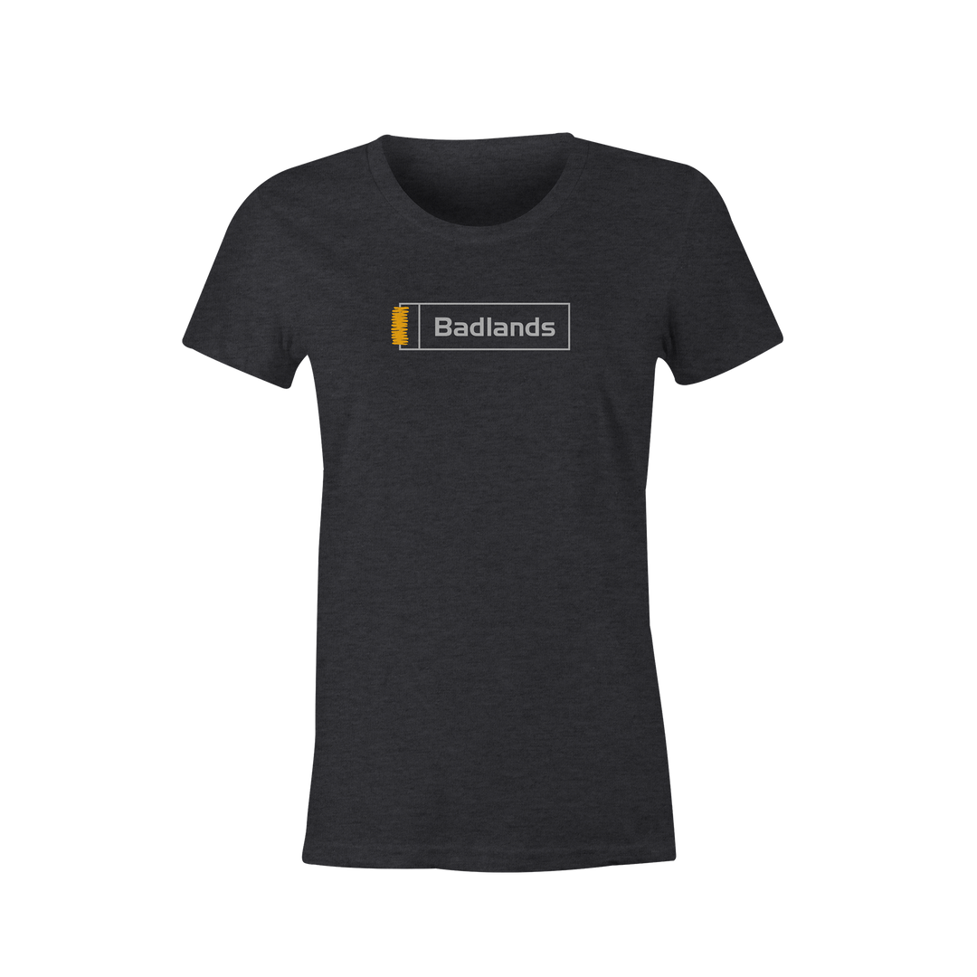 Charcoal t-shirt with Badlands logo and yellow skull graphic centered on chest. Simple, high-contrast design.