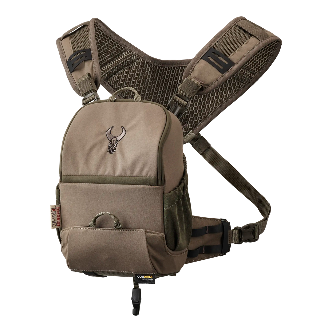 Tan Badlands binocular harness with mesh straps and skull logo, designed for outdoor use and easy gear access.
