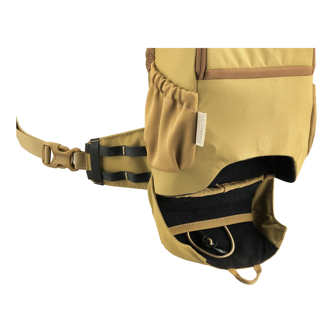 Tan Badlands pack hip belt with open zippered pocket, showing the Badlands skull logo inside.