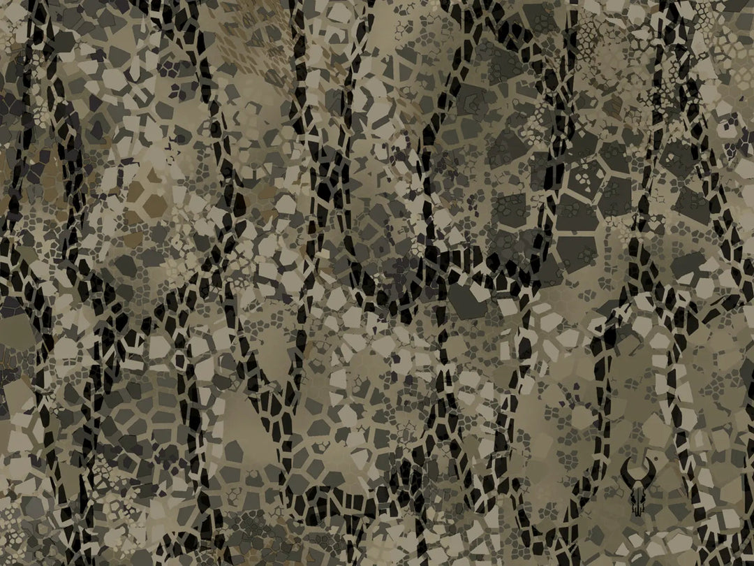 Tan and gray Badlands camo pattern with abstract shapes and a small Badlands skull logo in the lower right corner.
