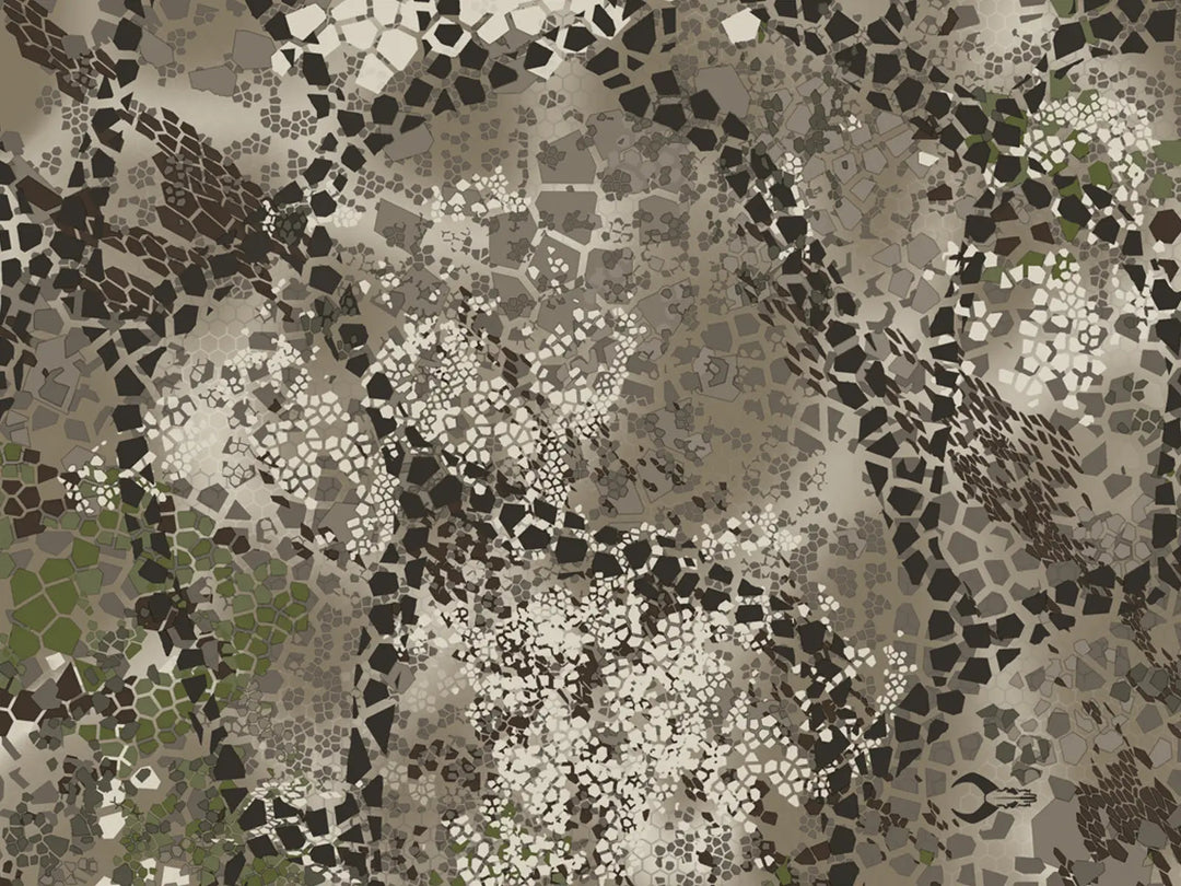 Badlands camo pattern with earth tones, mosaic shapes, and a subtle Badlands skull logo near the lower right.