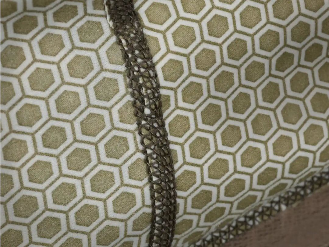 Close-up of Badlands fabric with hexagonal pattern and reinforced stitching; no visible Badlands skull logo.