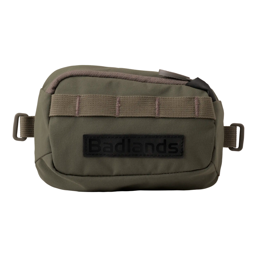 Olive green Badlands pouch with zipper, front webbing, and black Badlands logo patch. Compact and accessible design.