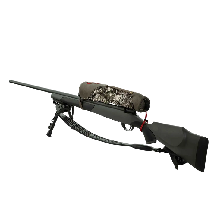 Badlands camo rifle case with skull logo, secured on a black hunting rifle with bipod, isolated on white background.