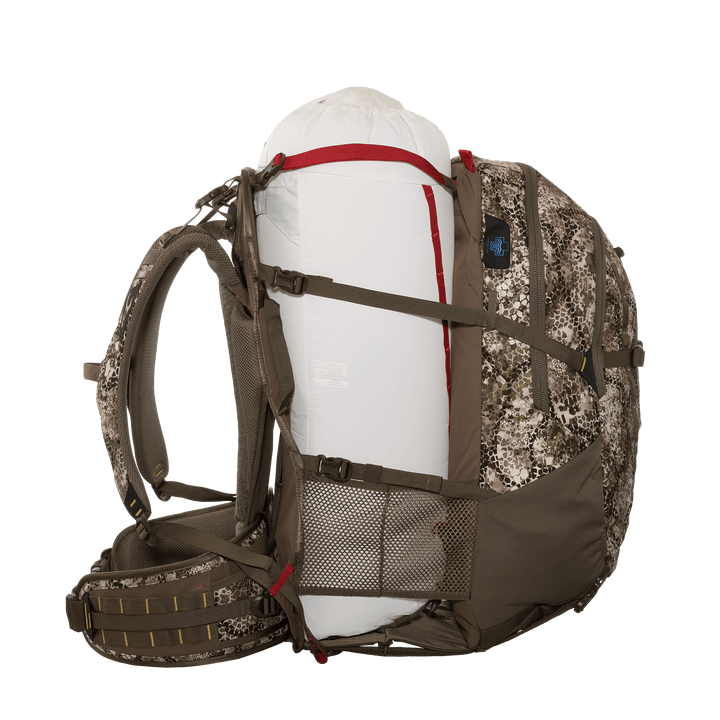 Badlands camo hunting pack with skull logo, loaded with gear, side mesh pocket and adjustable straps for support.