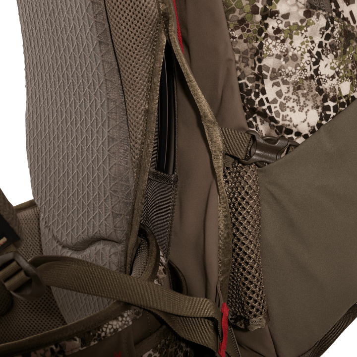 Close-up of Badlands hunting pack with mesh pocket, adjustable straps, and camo fabric; skull logo not visible.
