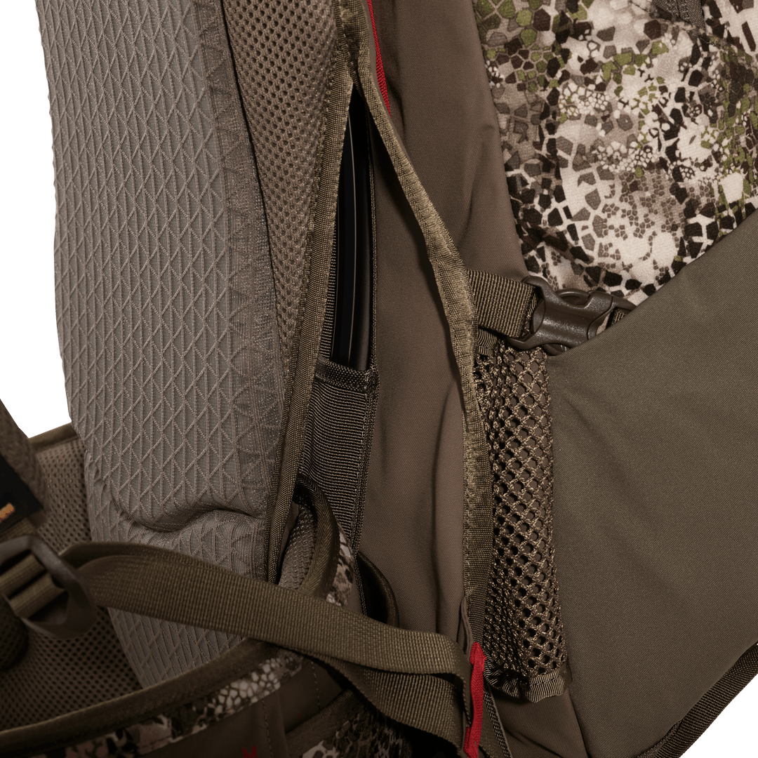 Close-up of Badlands hunting pack with mesh pocket, camo fabric, and visible skull logo on padded strap.