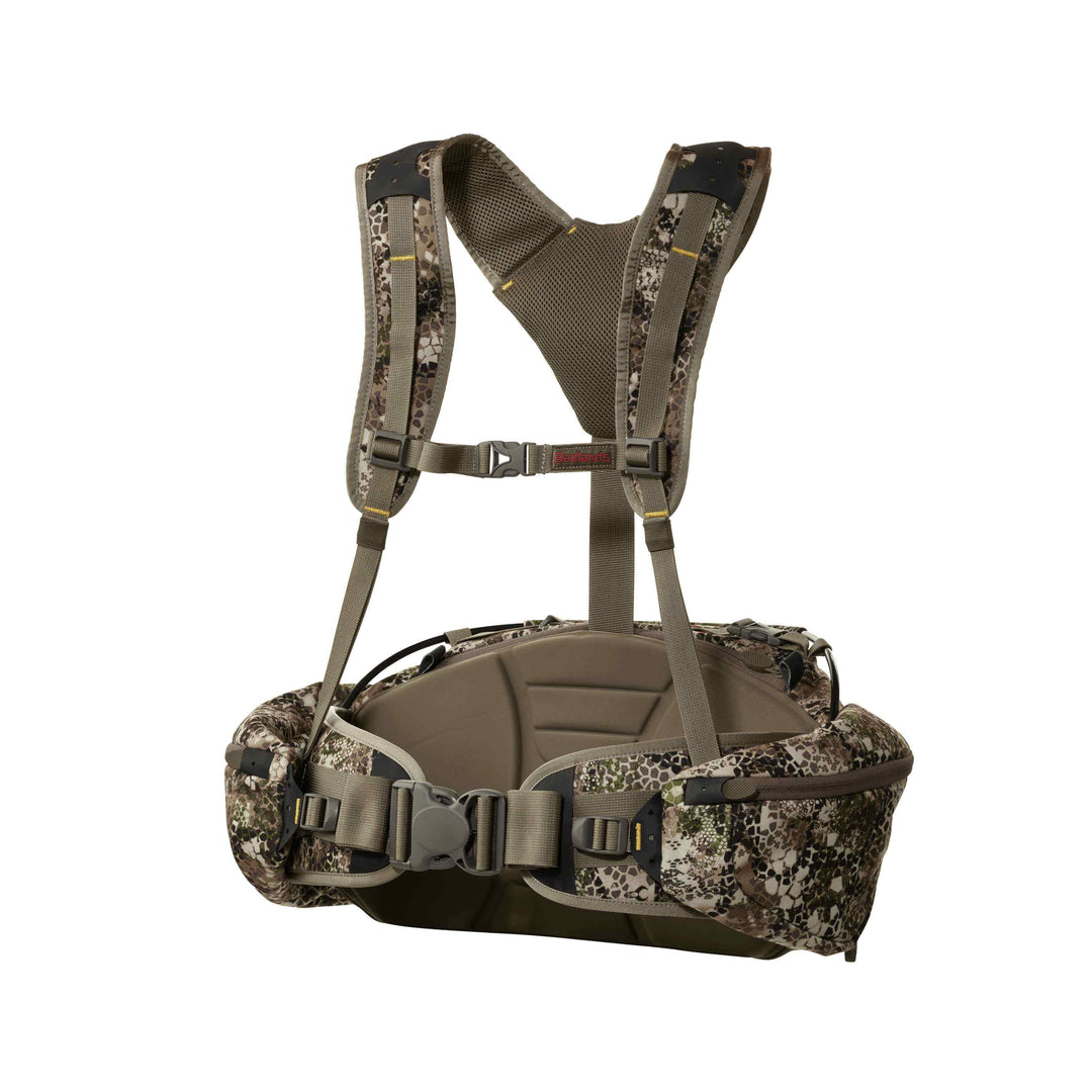 Badlands camo hunting pack with padded straps, waist belt, and skull logo. Accessible, ergonomic design for outdoor use.