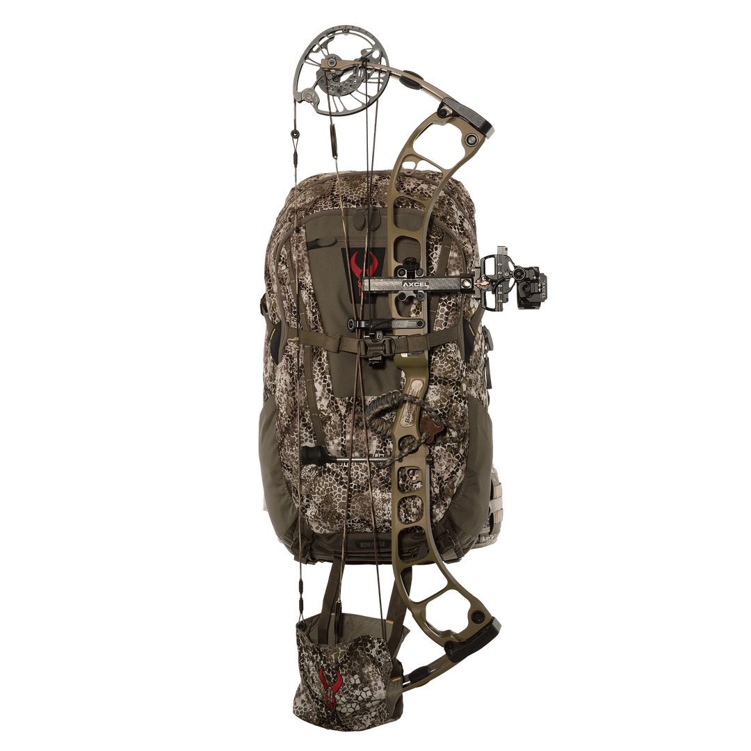 Badlands camo hunting backpack with bow holder and red skull logo, shown with compound bow attached.