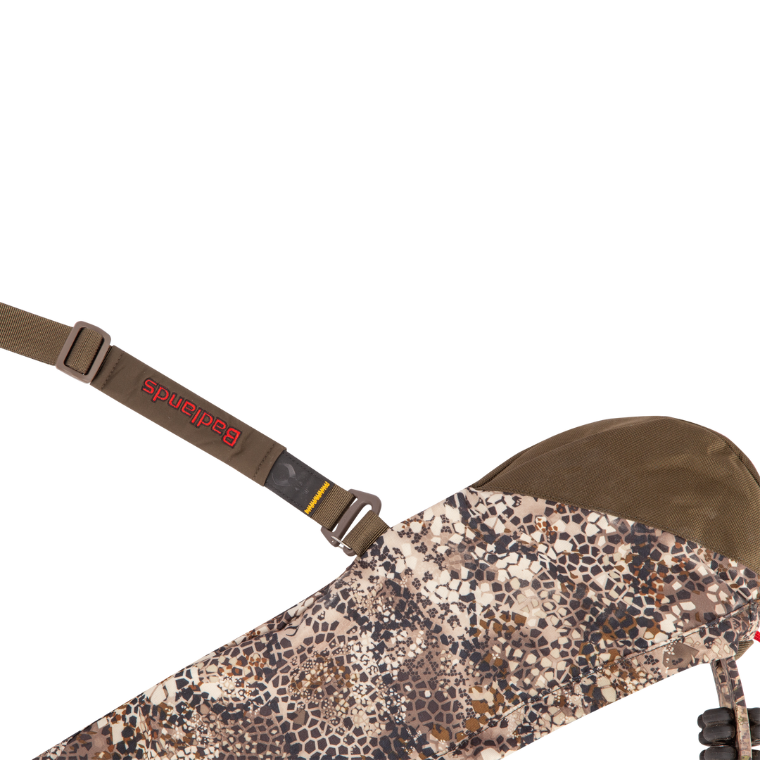 Badlands camo sling with red Badlands logo and skull emblem, adjustable strap, and durable fabric for outdoor use.