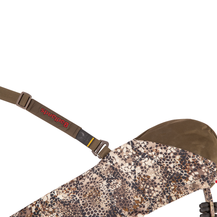 Badlands camo sling with red Badlands logo and skull emblem, adjustable strap, and durable fabric for outdoor use.