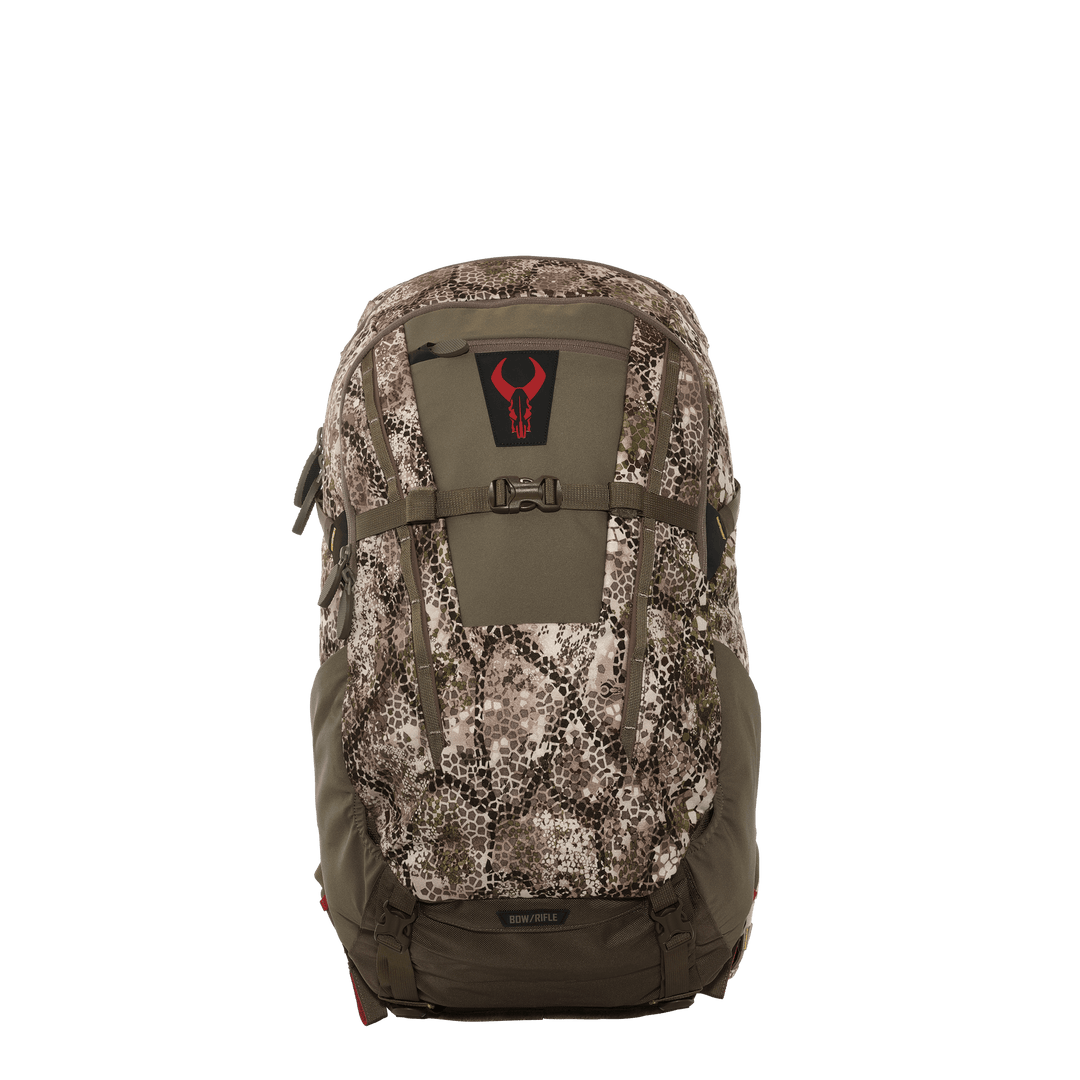 Badlands camo hunting backpack with red skull logo, front view, bow/rifle attachment, accessible pockets.