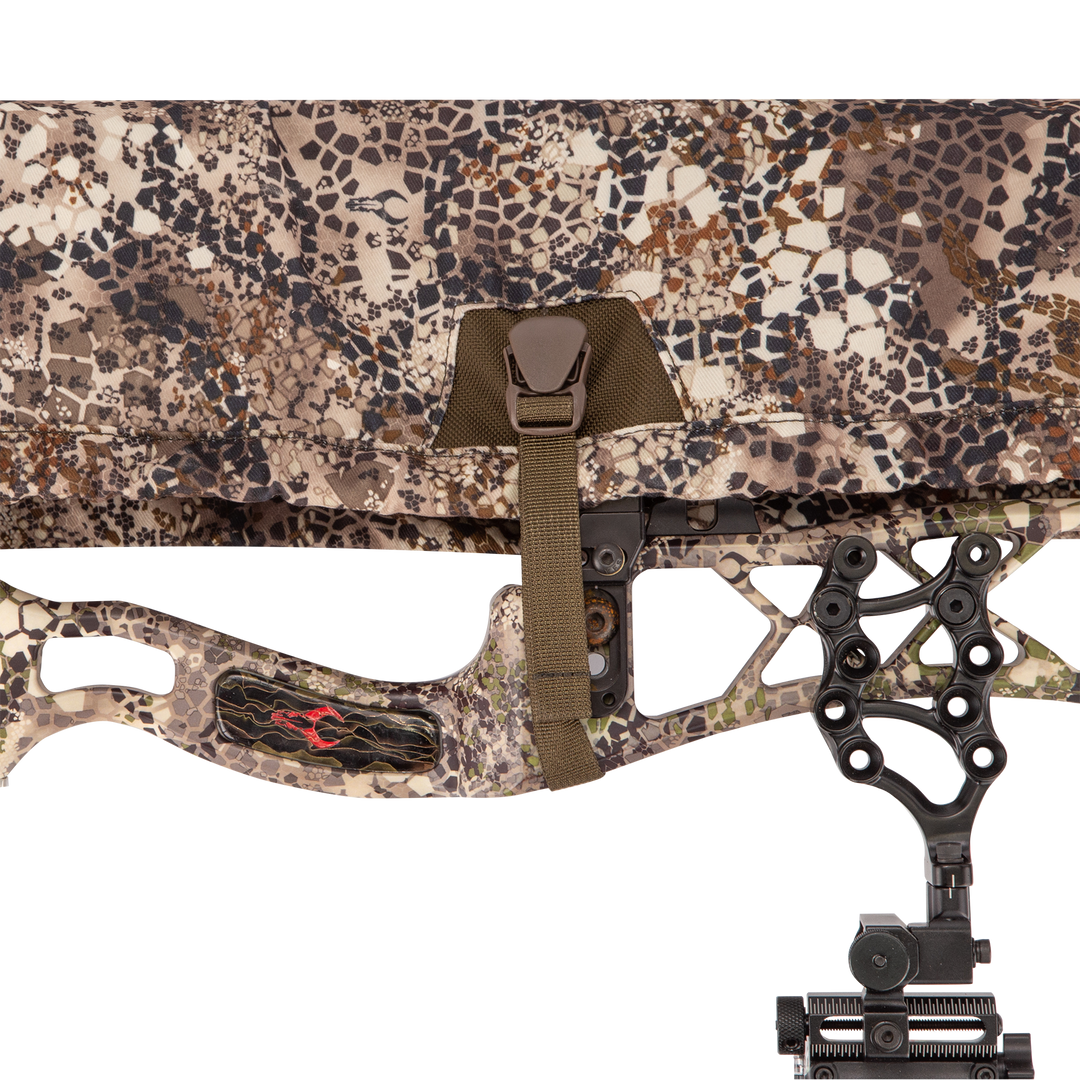 Badlands camo bow case with Badlands skull logo, buckle closure, and part of a compound bow visible.