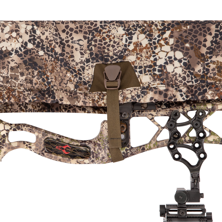 Badlands camo bow case with Badlands skull logo, buckle closure, and part of a compound bow visible.
