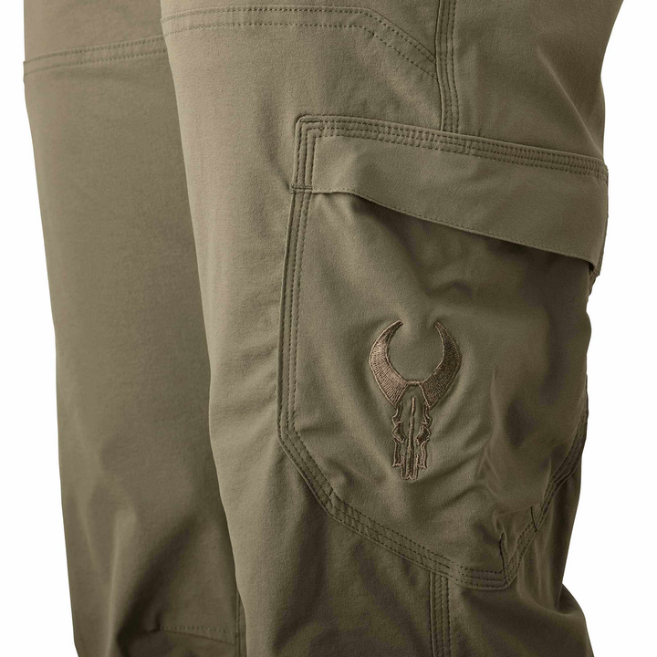 Olive cargo pants with Badlands skull logo embroidered on the pocket; close-up view of durable stitching.
