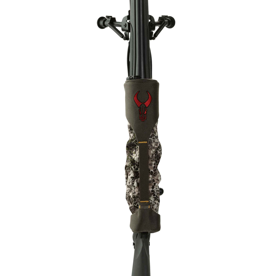 Badlands rifle cover with red skull logo, camo pattern, protects firearm barrel and scope; front view.