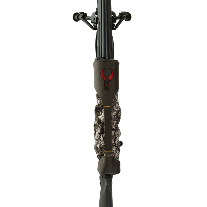 Badlands rifle cover with red skull logo, camo pattern, protects firearm barrel and scope; front view.