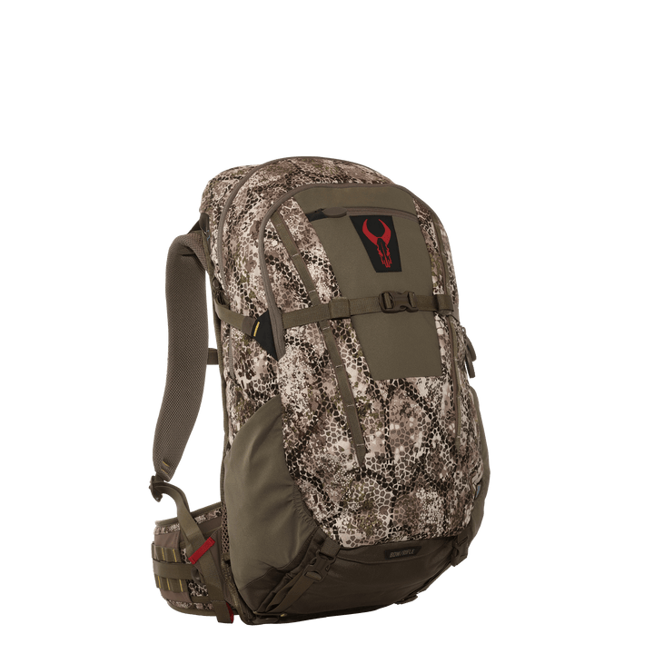 Camo Badlands hunting backpack with red skull logo, padded straps, and multiple compartments for outdoor gear.