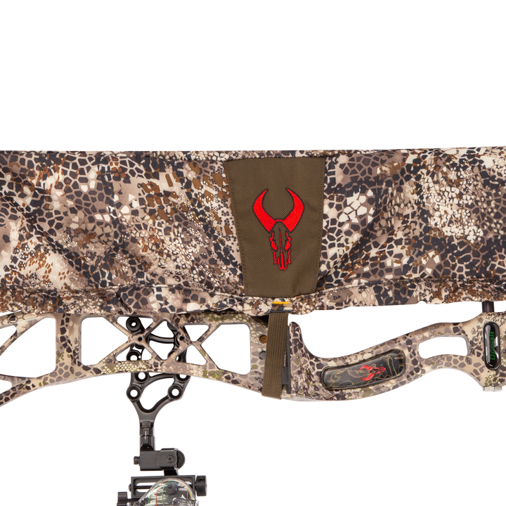 Badlands camo bow cover with red skull logo, shown on a compound bow. High-contrast pattern for outdoor use.