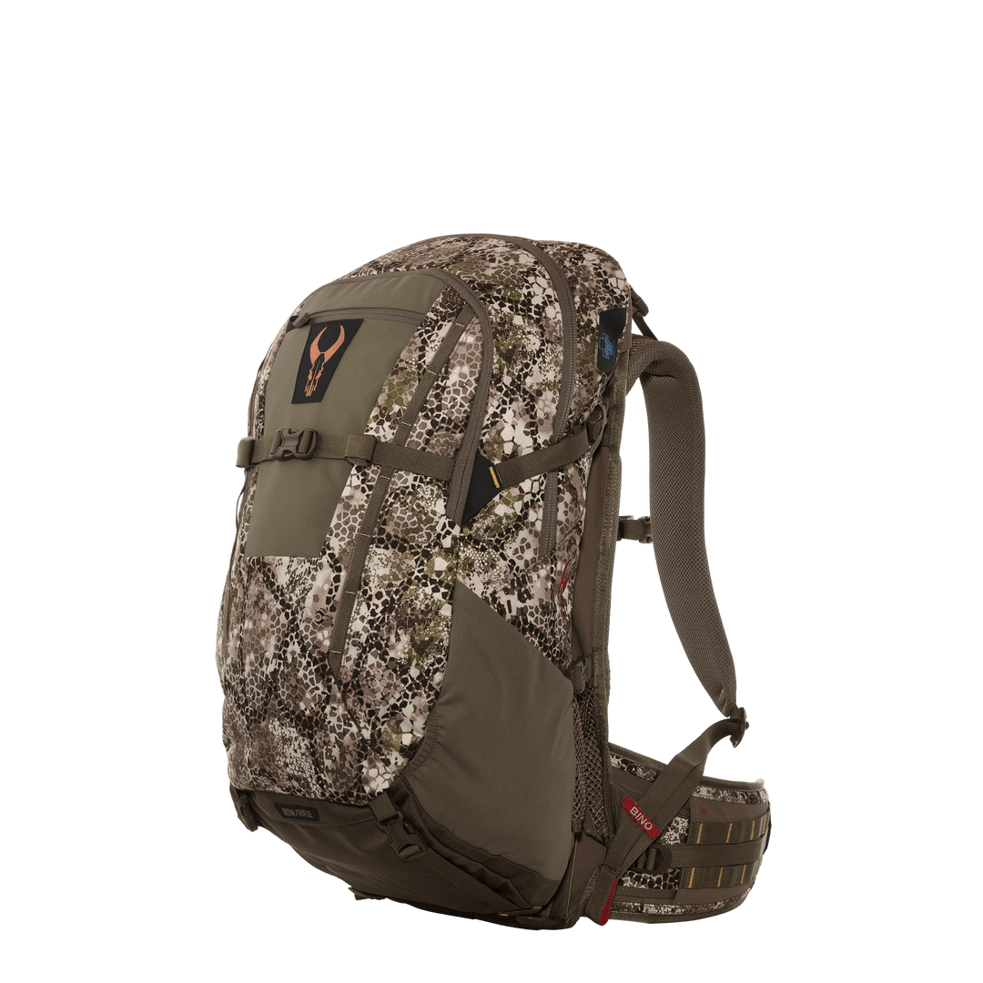 Badlands camo hunting backpack with padded straps and skull logo, shown at an angle on a plain background.